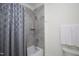 Bathroom with hexagon tiled shower and patterned shower curtain at 2120 Kipawa St, Raleigh, NC 27607