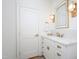Well-lit powder room with marble countertop, a decorative mirror, and modern fixtures at 2120 Kipawa St, Raleigh, NC 27607