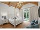 Bedroom with cathedral ceiling, exposed beams, four poster bed, and French doors leading to the backyard at 2120 Kipawa St, Raleigh, NC 27607
