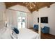 Bedroom with cathedral ceiling, exposed beams, king bed, and French doors leading to the backyard at 2120 Kipawa St, Raleigh, NC 27607