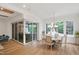 Open concept dining room features hardwood floors, many windows, and folding doors to an outdoor living area at 2120 Kipawa St, Raleigh, NC 27607