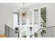Bright open foyer with a chandelier, hardwood floors, high ceilings, and oversized windows at 2120 Kipawa St, Raleigh, NC 27607