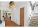 Entryway with hardwood floors, chandelier, stairway, and an open concept view into the living room at 2120 Kipawa St, Raleigh, NC 27607