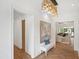 Hallway with hardwood floors, chandelier, bench, and an open concept view into the living room at 2120 Kipawa St, Raleigh, NC 27607