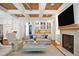 Living room with coffered ceilings, fireplace, and sofa with blue accents, perfect for relaxing at 2120 Kipawa St, Raleigh, NC 27607