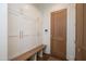 Well-designed mudroom with custom storage, a wooden bench, and a stylish doorway at 2120 Kipawa St, Raleigh, NC 27607