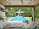 Stylish outdoor living space with a covered patio, grill, and pool with gazebo in background at 2120 Kipawa St, Raleigh, NC 27607