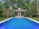 Backyard pool with a fireplace and outdoor seating in a cabana at 2120 Kipawa St, Raleigh, NC 27607