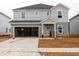 Under construction, two-story home boasts a two-car garage, neutral siding, and a modern design at 2242 Cherry Creek Rd, Haw River, NC 27258