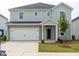 Charming two-story home with a two-car garage and landscaped front yard at 2242 Cherry Creek Rd, Haw River, NC 27258