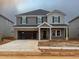 Two-story home featuring gray siding, brick accents, and an attached two-car garage at 2246 Cherry Creek Rd, Haw River, NC 27258