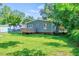 This home features a well-maintained lawn and a charming wooden deck, ideal for relaxation and entertainment at 230 Parkland Rd, Raleigh, NC 27603
