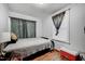 Bedroom with hardwood floors, neutral walls, and ample natural light from the window at 230 Parkland Rd, Raleigh, NC 27603