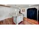 This kitchen features a granite topped island, white cabinets and hardwood floors at 230 Parkland Rd, Raleigh, NC 27603