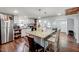 Bright kitchen features a granite-topped island, white cabinets, and stainless steel refrigerator at 230 Parkland Rd, Raleigh, NC 27603