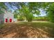 Large, shady backyard with mature trees and wooden fence at 2309 Hoot Owl Ct, Raleigh, NC 27603