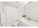 Bathroom with modern vanity, fixtures, shower/tub with shower curtain, and large mirror at 2309 Hoot Owl Ct, Raleigh, NC 27603