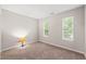 Bright bedroom with carpet and two windows at 2309 Hoot Owl Ct, Raleigh, NC 27603
