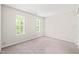 Bright bedroom with two windows, neutral walls, and carpet flooring at 2309 Hoot Owl Ct, Raleigh, NC 27603
