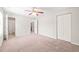 Spacious bedroom with ceiling fan and large closet doors at 2309 Hoot Owl Ct, Raleigh, NC 27603