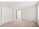 Bedroom featuring carpet, neutral walls, double closet and access to another room at 2309 Hoot Owl Ct, Raleigh, NC 27603