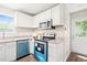 Bright kitchen with white cabinetry, stainless steel appliances, and granite countertops at 2309 Hoot Owl Ct, Raleigh, NC 27603