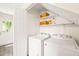 Convenient laundry room with washer, dryer, and ample shelving for storage at 2309 Hoot Owl Ct, Raleigh, NC 27603