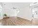 Bright living room with wood floors, a ceiling fan, and open access to the kitchen area at 2309 Hoot Owl Ct, Raleigh, NC 27603