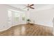 Sun-drenched living room features wood floors, large bay windows and a modern ceiling fan at 2309 Hoot Owl Ct, Raleigh, NC 27603