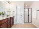 Bright bathroom featuring a double vanity, granite countertops, and a modern glass shower at 233 Hammond Wood Place, Morrisville, NC 27560