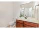 Bathroom featuring tile flooring, wood cabinet and a mirror over the sink at 233 Hammond Wood Place, Morrisville, NC 27560