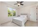 Comfortable bedroom with neutral carpet and decor and a large window at 233 Hammond Wood Place, Morrisville, NC 27560