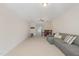 Spacious bonus room area with neutral carpet, a ceiling fan and seating area at 233 Hammond Wood Place, Morrisville, NC 27560