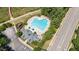 Aerial view of a community pool, clubhouse, playground, and parking lot at 233 Hammond Wood Place, Morrisville, NC 27560