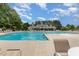 Community swimming pool featuring lap lanes, lounge chairs, and a view of the clubhouse at 233 Hammond Wood Place, Morrisville, NC 27560