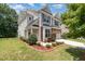 Beautiful two-story home with brick accents, manicured landscaping, and a well-maintained lawn at 233 Hammond Wood Place, Morrisville, NC 27560