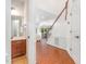 Bright foyer with hardwood floors, staircase, and convenient access to a half-bathroom at 233 Hammond Wood Place, Morrisville, NC 27560