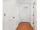 Hallway featuring gleaming hardwood floors and white trim, leading to various rooms in the home at 233 Hammond Wood Place, Morrisville, NC 27560