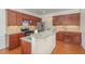 Bright kitchen with granite countertops, stainless appliances, and wood flooring at 233 Hammond Wood Place, Morrisville, NC 27560