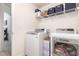 Laundry room featuring a washer, dryer, and wire shelving for storage at 233 Hammond Wood Place, Morrisville, NC 27560