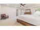 Bright main bedroom features a ceiling fan, neutral carpet, and a cozy chair at 233 Hammond Wood Place, Morrisville, NC 27560