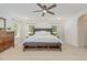 Bright primary bedroom with neutral carpet, a ceiling fan, and natural light at 233 Hammond Wood Place, Morrisville, NC 27560