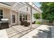 Back patio with pergola, pavers, grill, and comfortable seating, perfect for outdoor gatherings and relaxation at 233 Hammond Wood Place, Morrisville, NC 27560