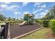 An outdoor playground with a slide and play structure, surrounded by landscaping at 233 Hammond Wood Place, Morrisville, NC 27560