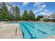A view of the rectangular community swimming pool with lap lanes and lounge chairs at 233 Hammond Wood Place, Morrisville, NC 27560