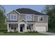 Charming two-story home featuring a covered front porch and a two-car garage at 2341 Horton Park Dr, Apex, NC 27539