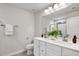 Bathroom with a double sink vanity, a large mirror, and modern fixtures at 240 Amber Acorn Ave, Raleigh, NC 27603