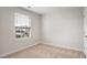 Cozy bedroom featuring plush carpet, a single window, and a light and neutral color palette at 240 Amber Acorn Ave, Raleigh, NC 27603