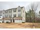 Charming two-story townhome showcasing a brick facade, attached garage, and well-maintained landscaping at 240 Amber Acorn Ave, Raleigh, NC 27603