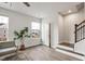 Bright living room with large windows, stairs, and space for a sitting area at 240 Amber Acorn Ave, Raleigh, NC 27603
